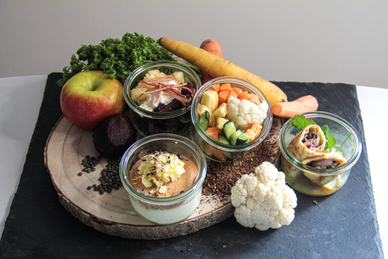 Portions individuelles en bocaux entourées de légumes bruts (carotte, chou-fleur, betterave, pomme) — solution anti-gaspillage de La Cuisine de Demain à Strasbourg